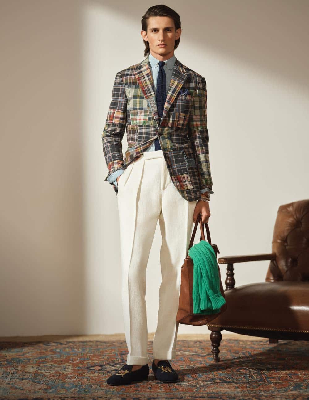 Man wears a madras suit and white pants.